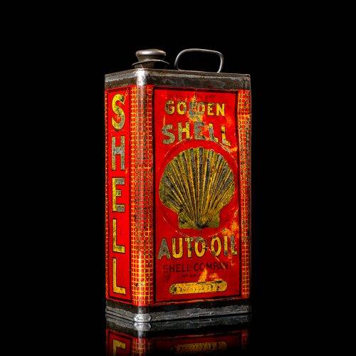 Vintage Shell oil cans with red and yellow branding from the 1900-1920 old logo Vintage Shell oil cans from 1900-19255, featuring the old logo. The photo showcases an antique tin red with yellow accents, displaying the historic Shell emblem. Shot in a studio against a solid black background