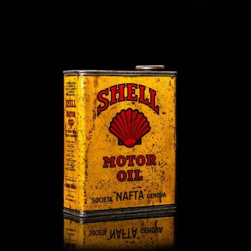 Vintage Shell oil cans with red and yellow branding from the 1900-1920 old logo Vintage Shell oil cans from 1900-19255, featuring the old logo. The photo showcases an antique tin red with yellow accents, displaying the historic Shell emblem. Shot in a studio against a solid black background