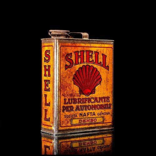 Vintage Shell oil cans with red and yellow branding from the 1900-1920 old logo Vintage Shell oil cans from 1900-19255, featuring the old logo. The photo showcases an antique tin red with yellow accents, displaying the historic Shell emblem. Shot in a studio against a solid black background