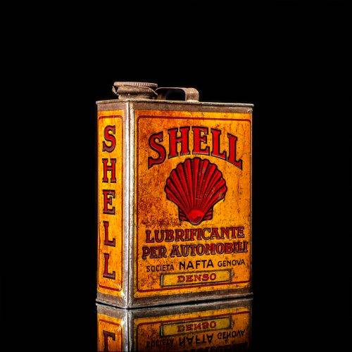 Vintage Shell oil cans with red and yellow branding from the 1900-1920 old logo Vintage Shell oil cans from 1900-19255, featuring the old logo. The photo showcases an antique tin red with yellow accents, displaying the historic Shell emblem. Shot in a studio against a solid black background