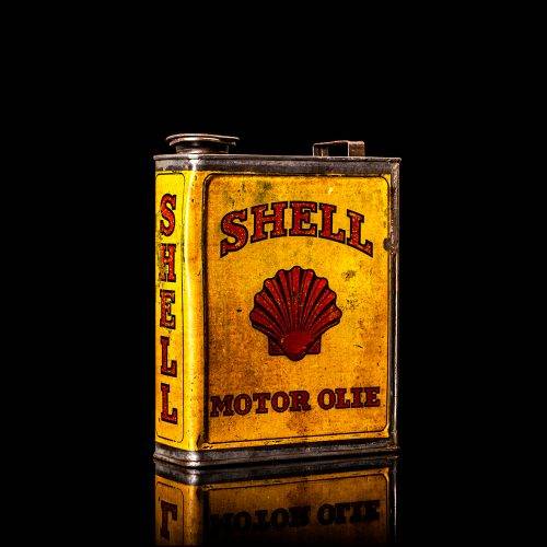 Vintage Shell oil cans with red and yellow branding from the 1900-1920 old logo Vintage Shell oil cans from 1900-19255, featuring the old logo. The photo showcases an antique tin red with yellow accents, displaying the historic Shell emblem. Shot in a studio against a solid black background