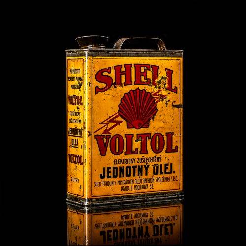 Vintage Shell oil cans with red and yellow branding from the 1900-1920 old logo Vintage Shell oil cans from 1900-19255, featuring the old logo. The photo showcases an antique tin red with yellow accents, displaying the historic Shell emblem. Shot in a studio against a solid black background