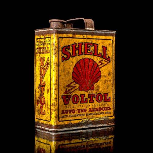 Vintage Shell oil cans with red and yellow branding from the 1900-1920 old logo Vintage Shell oil cans from 1900-19255, featuring the old logo. The photo showcases an antique tin red with yellow accents, displaying the historic Shell emblem. Shot in a studio against a solid black background