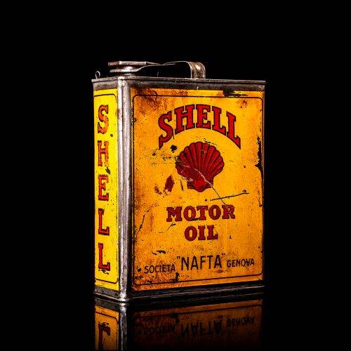 Vintage Shell oil cans with red and yellow branding from the 1900-1920 old logo Vintage Shell oil cans from 1900-19255, featuring the old logo. The photo showcases an antique tin red with yellow accents, displaying the historic Shell emblem. Shot in a studio against a solid black background