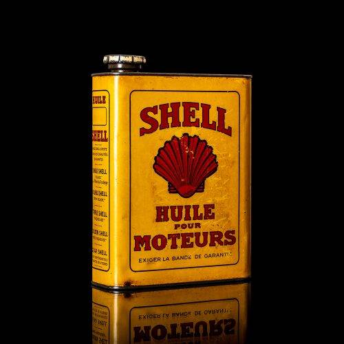 Vintage Shell oil cans with red and yellow branding from the 1900-1920 old logo Vintage Shell oil cans from 1900-19255, featuring the old logo. The photo showcases an antique tin red with yellow accents, displaying the historic Shell emblem. Shot in a studio against a solid black background