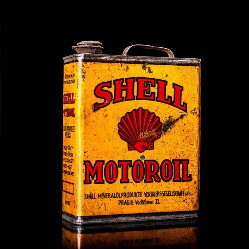 Vintage Shell oil cans with red and yellow branding from the 1900-1920 old logo Vintage Shell oil cans from 1900-19255, featuring the old logo. The photo showcases an antique tin red with yellow accents, displaying the historic Shell emblem. Shot in a studio against a solid black background