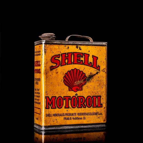 Vintage Shell oil cans with red and yellow branding from the 1900-1920 old logo Vintage Shell oil cans from 1900-19255, featuring the old logo. The photo showcases an antique tin red with yellow accents, displaying the historic Shell emblem. Shot in a studio against a solid black background