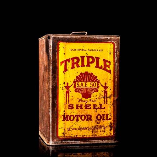 Vintage Shell oil cans with red and yellow branding from the 1900-1920 old logo Vintage Shell oil cans from 1900-19255, featuring the old logo. The photo showcases an antique tin red with yellow accents, displaying the historic Shell emblem. Shot in a studio against a solid black background