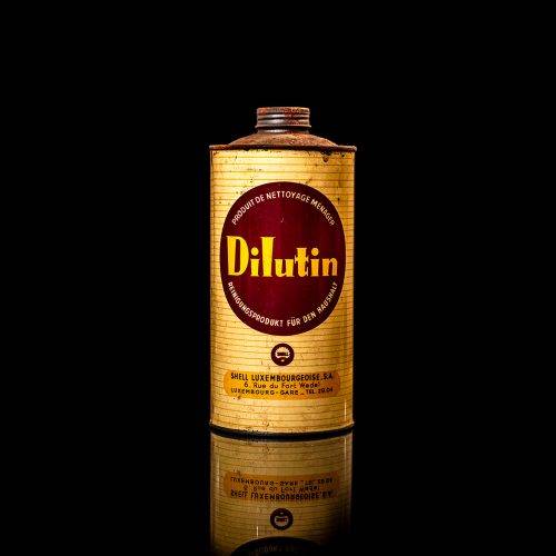 Vintage Shell oil cans with red and yellow branding from the 1900-1920 old logo Vintage Shell oil cans from 1900-19255, featuring the old logo. The photo showcases an antique tin red with yellow accents, displaying the historic Shell emblem. Shot in a studio against a solid black background