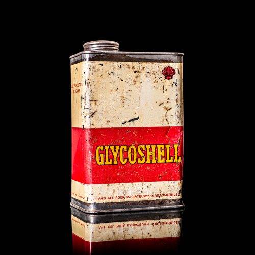 Vintage Shell oil cans with red and yellow branding from the 1900-1920 old logo Vintage Shell oil cans from 1900-19255, featuring the old logo. The photo showcases an antique tin red with yellow accents, displaying the historic Shell emblem. Shot in a studio against a solid black background