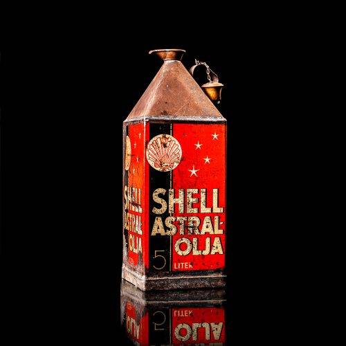 Vintage Shell oil cans with red and yellow branding from the 1900-1920 old logo Vintage Shell oil cans from 1900-19255, featuring the old logo. The photo showcases an antique tin red with yellow accents, displaying the historic Shell emblem. Shot in a studio against a solid black background