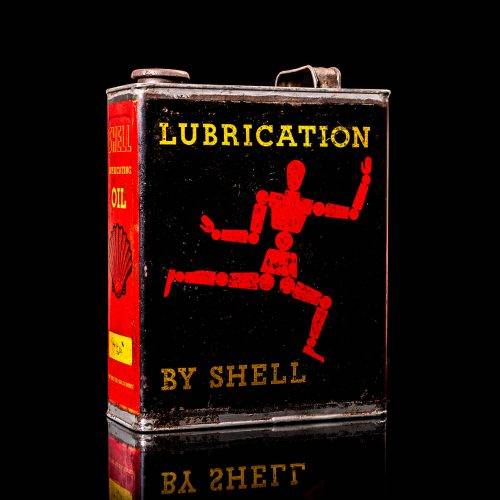 Vintage Shell oil cans with red and yellow branding from the 1900-1920 old logo Vintage Shell oil cans from 1900-19255, featuring the old logo. The photo showcases an antique tin red with yellow accents, displaying the historic Shell emblem. Shot in a studio against a solid black background