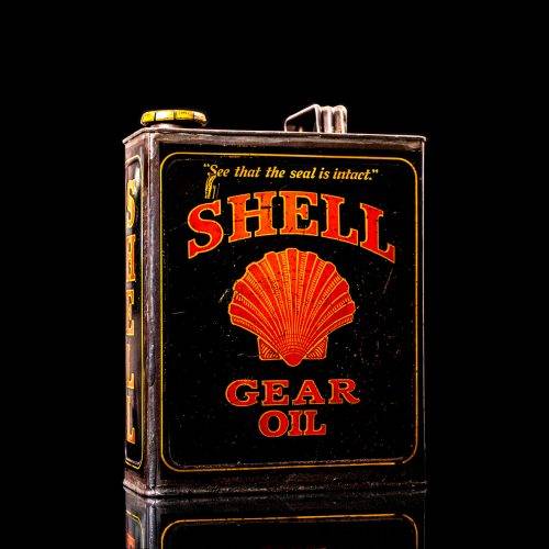 Vintage Shell oil cans with red and yellow branding from the 1900-1920 old logo Vintage Shell oil cans from 1900-19255, featuring the old logo. The photo showcases an antique tin red with yellow accents, displaying the historic Shell emblem. Shot in a studio against a solid black background