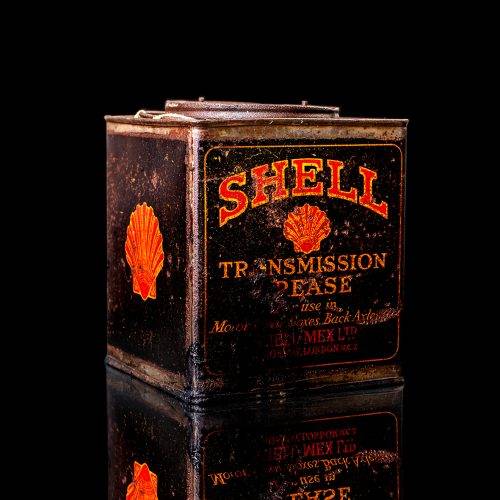 Vintage Shell oil cans with red and yellow branding from the 1900-1920 old logo Vintage Shell oil cans from 1900-19255, featuring the old logo. The photo showcases an antique tin red with yellow accents, displaying the historic Shell emblem. Shot in a studio against a solid black background