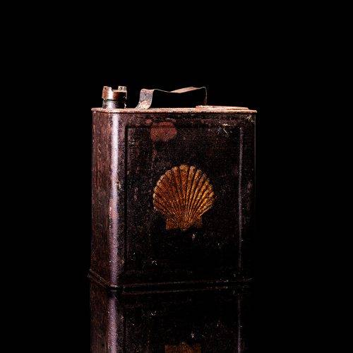 Vintage Shell oil cans with red and yellow branding from the 1900-1920 old logo Vintage Shell oil cans from 1900-19255, featuring the old logo. The photo showcases an antique tin red with yellow accents, displaying the historic Shell emblem. Shot in a studio against a solid black background