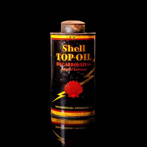 Vintage Shell oil cans with red and yellow branding from the 1900-1920 old logo Vintage Shell oil cans from 1900-19255, featuring the old logo. The photo showcases an antique tin red with yellow accents, displaying the historic Shell emblem. Shot in a studio against a solid black background