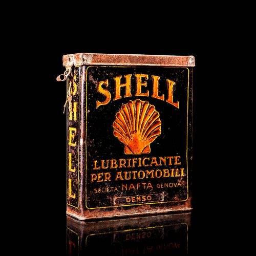 Vintage Shell oil cans with red and yellow branding from the 1900-1920 old logo Vintage Shell oil cans from 1900-19255, featuring the old logo. The photo showcases an antique tin red with yellow accents, displaying the historic Shell emblem. Shot in a studio against a solid black background