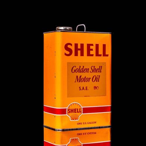Vintage Shell oil cans with red and yellow branding from the 1900-1920 old logo Vintage Shell oil cans from 1900-19255, featuring the old logo. The photo showcases an antique tin red with yellow accents, displaying the historic Shell emblem. Shot in a studio against a solid black background