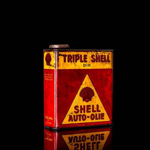 Vintage Shell oil cans with red and yellow branding from the 1900-1920 old logo Vintage Shell oil cans from 1900-19255, featuring the old logo. The photo showcases an antique tin red with yellow accents, displaying the historic Shell emblem. Shot in a studio against a solid black background