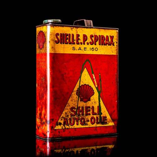 Vintage Shell oil cans with red and yellow branding from the 1900-1920 old logo Vintage Shell oil cans from 1900-19255, featuring the old logo. The photo showcases an antique tin red with yellow accents, displaying the historic Shell emblem. Shot in a studio against a solid black background