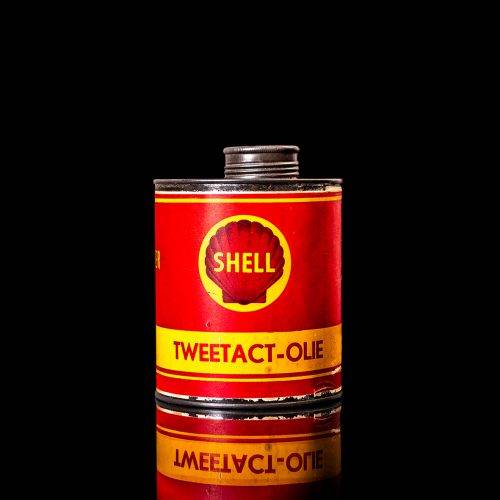 Vintage Shell oil cans with red and yellow branding from the 1900-1920 old logo Vintage Shell oil cans from 1900-19255, featuring the old logo. The photo showcases an antique tin red with yellow accents, displaying the historic Shell emblem. Shot in a studio against a solid black background
