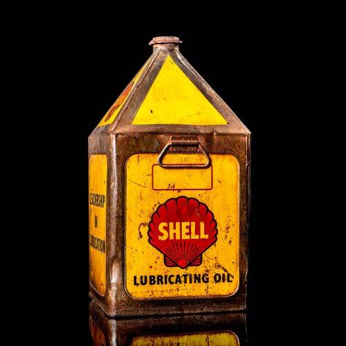 Vintage Shell oil cans with red and yellow branding from the 1900-1920 old logo Vintage Shell oil cans from 1900-19255, featuring the old logo. The photo showcases an antique tin red with yellow accents, displaying the historic Shell emblem. Shot in a studio against a solid black background