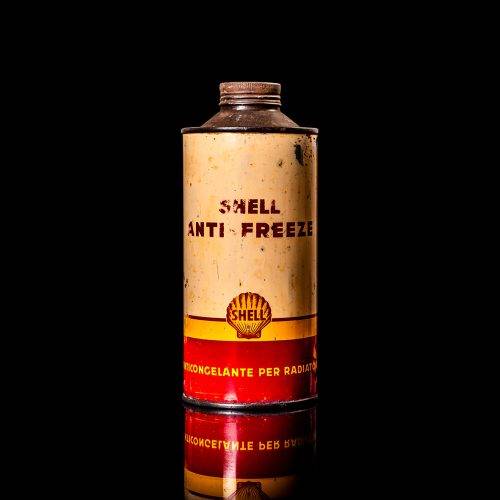 Vintage Shell oil cans with red and yellow branding from the 1900-1920 old logo Vintage Shell oil cans from 1900-19255, featuring the old logo. The photo showcases an antique tin red with yellow accents, displaying the historic Shell emblem. Shot in a studio against a solid black background