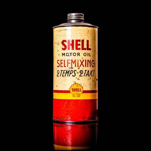 Vintage Shell oil cans with red and yellow branding from the 1900-1920 old logo Vintage Shell oil cans from 1900-19255, featuring the old logo. The photo showcases an antique tin red with yellow accents, displaying the historic Shell emblem. Shot in a studio against a solid black background