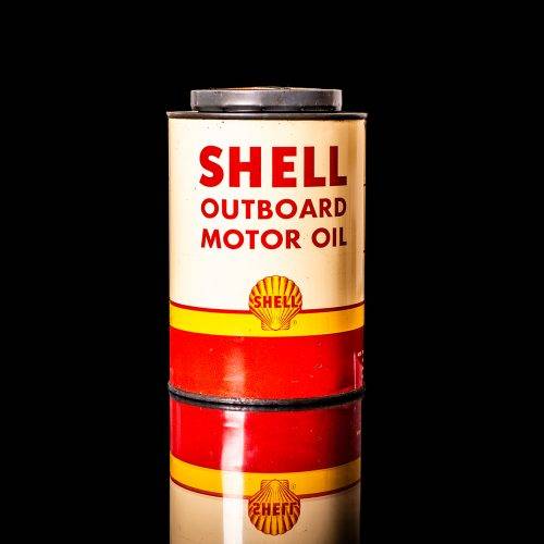 Vintage Shell oil cans with red and yellow branding from the 1900-1920 old logo Vintage Shell oil cans from 1900-19255, featuring the old logo. The photo showcases an antique tin red with yellow accents, displaying the historic Shell emblem. Shot in a studio against a solid black background