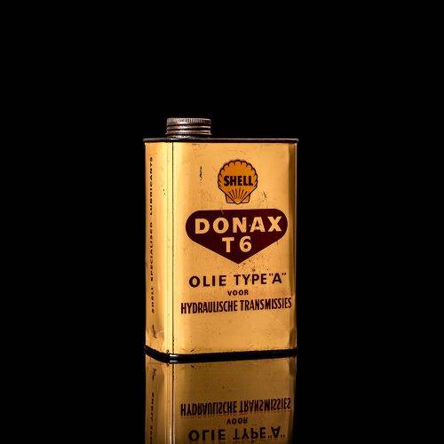 Vintage Shell oil cans with red and yellow branding from the 1900-1920 old logo Vintage Shell oil cans from 1900-19255, featuring the old logo. The photo showcases an antique tin red with yellow accents, displaying the historic Shell emblem. Shot in a studio against a solid black background