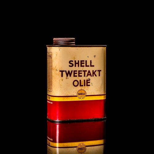 Vintage Shell oil cans with red and yellow branding from the 1900-1920 old logo Vintage Shell oil cans from 1900-19255, featuring the old logo. The photo showcases an antique tin red with yellow accents, displaying the historic Shell emblem. Shot in a studio against a solid black background