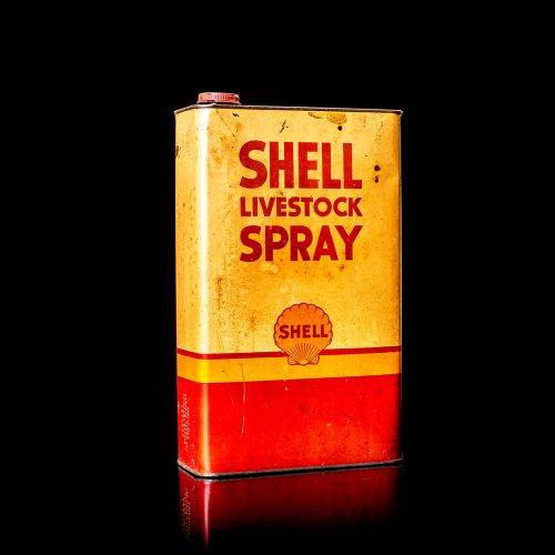 Vintage Shell oil cans with red and yellow branding from the 1900-1920 old logo Vintage Shell oil cans from 1900-19255, featuring the old logo. The photo showcases an antique tin red with yellow accents, displaying the historic Shell emblem. Shot in a studio against a solid black background