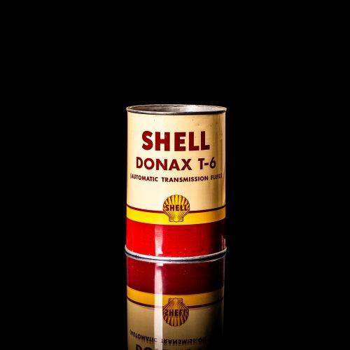 Vintage Shell oil cans with red and yellow branding from the 1900-1920 old logo Vintage Shell oil cans from 1900-19255, featuring the old logo. The photo showcases an antique tin red with yellow accents, displaying the historic Shell emblem. Shot in a studio against a solid black background