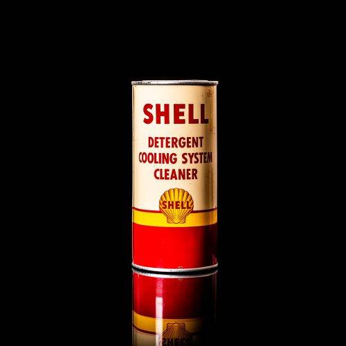 Vintage Shell oil cans with red and yellow branding from the 1900-1920 old logo Vintage Shell oil cans from 1900-19255, featuring the old logo. The photo showcases an antique tin red with yellow accents, displaying the historic Shell emblem. Shot in a studio against a solid black background