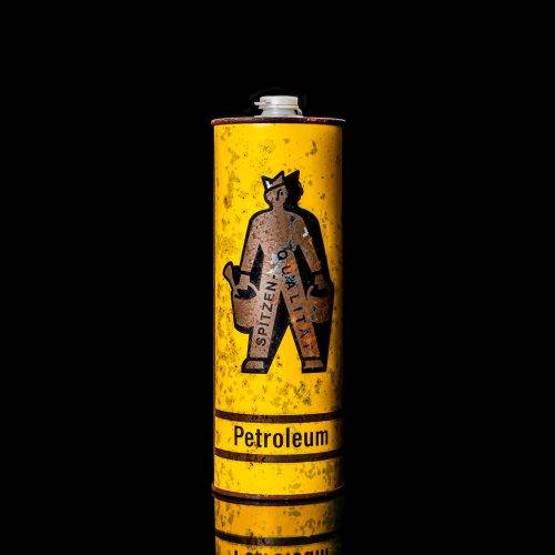 Vintage Shell oil cans with red and yellow branding from the 1900-1920 old logo Vintage Shell oil cans from 1900-19255, featuring the old logo. The photo showcases an antique tin red with yellow accents, displaying the historic Shell emblem. Shot in a studio against a solid black background