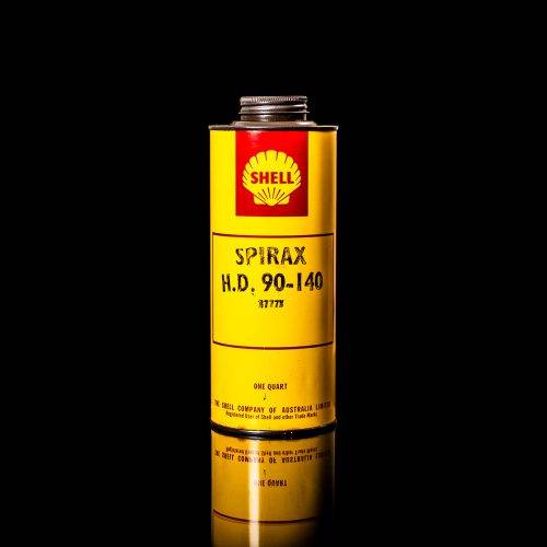 Vintage Shell oil cans with red and yellow branding from the 1900-1920 old logo Vintage Shell oil cans from 1900-19255, featuring the old logo. The photo showcases an antique tin red with yellow accents, displaying the historic Shell emblem. Shot in a studio against a solid black background