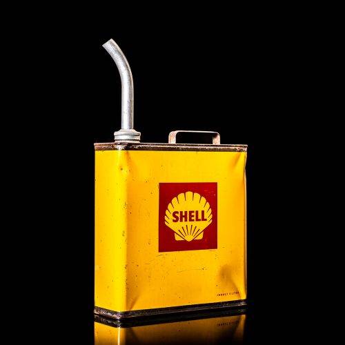 Vintage Shell oil cans with red and yellow branding from the 1900-1920 old logo Vintage Shell oil cans from 1900-19255, featuring the old logo. The photo showcases an antique tin red with yellow accents, displaying the historic Shell emblem. Shot in a studio against a solid black background