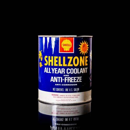 Vintage Shell oil cans with red and yellow branding from the 1900-1920 old logo Vintage Shell oil cans from 1900-19255, featuring the old logo. The photo showcases an antique tin red with yellow accents, displaying the historic Shell emblem. Shot in a studio against a solid black background