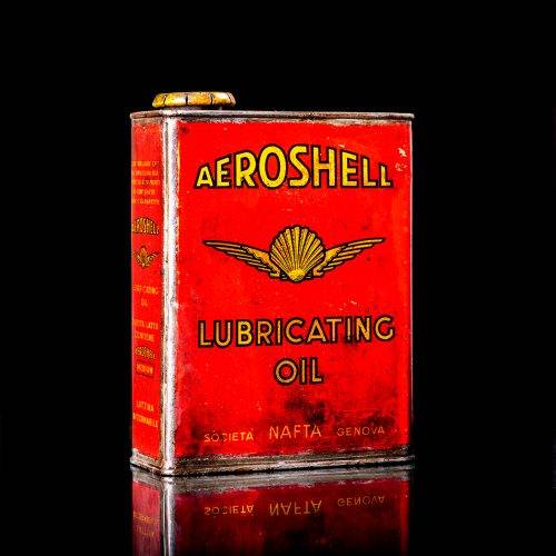 Vintage Shell oil cans with red and yellow branding from the 1900-1920 old logo Vintage Shell oil cans from 1900-19255, featuring the old logo. The photo showcases an antique tin red with yellow accents, displaying the historic Shell emblem. Shot in a studio against a solid black background