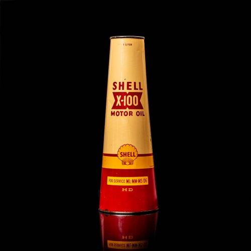 Vintage Shell oil cans with red and yellow branding from the 1900-1920 old logo Vintage Shell oil cans from 1900-19255, featuring the old logo. The photo showcases an antique tin red with yellow accents, displaying the historic Shell emblem. Shot in a studio against a solid black background