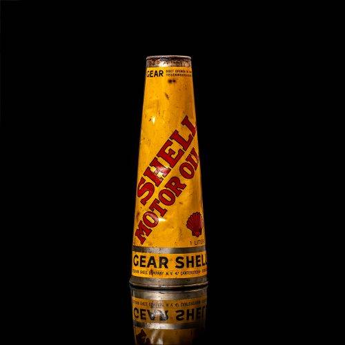 Vintage Shell oil cans with red and yellow branding from the 1900-1920 old logo Vintage Shell oil cans from 1900-19255, featuring the old logo. The photo showcases an antique tin red with yellow accents, displaying the historic Shell emblem. Shot in a studio against a solid black background