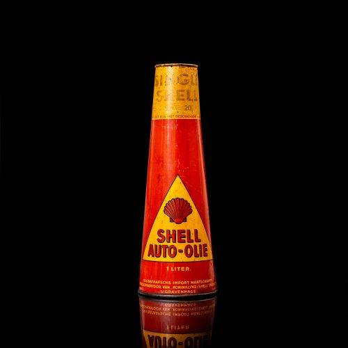 Vintage Shell oil cans with red and yellow branding from the 1900-1920 old logo Vintage Shell oil cans from 1900-19255, featuring the old logo. The photo showcases an antique tin red with yellow accents, displaying the historic Shell emblem. Shot in a studio against a solid black background