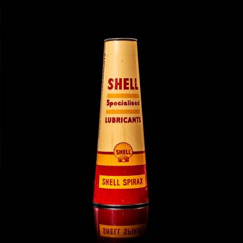 Vintage Shell oil cans with red and yellow branding from the 1900-1920 old logo Vintage Shell oil cans from 1900-19255, featuring the old logo. The photo showcases an antique tin red with yellow accents, displaying the historic Shell emblem. Shot in a studio against a solid black background