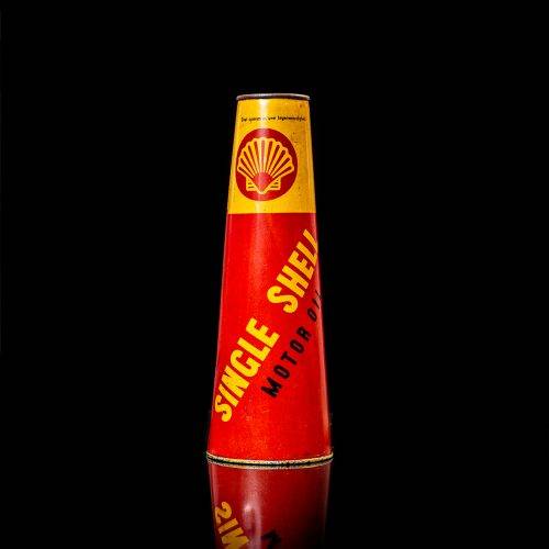 Vintage Shell oil cans with red and yellow branding from the 1900-1920 old logo Vintage Shell oil cans from 1900-19255, featuring the old logo. The photo showcases an antique tin red with yellow accents, displaying the historic Shell emblem. Shot in a studio against a solid black background