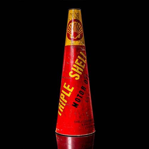Rare and unique vintage conical shell oil can from 1900–1950 with a red base and yellow accents, featuring the classic shell logo. This antique, cone-shaped motor oil tin is showcased in a studio setting against a solid black background."