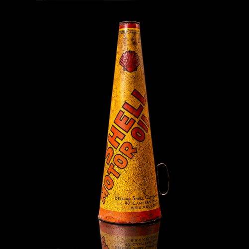 Rare and unique vintage conical shell oil can from 1900–1950 with a red base and yellow accents, featuring the classic shell logo. This antique, cone-shaped motor oil tin is showcased in a studio setting against a solid black background."