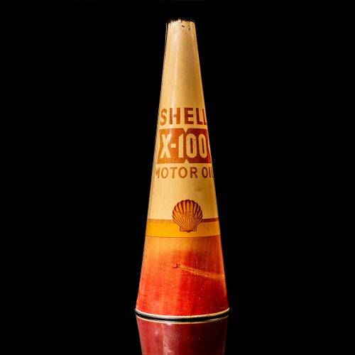 Rare and unique vintage conical shell oil can from 1900–1950 with a red base and yellow accents, featuring the classic shell logo. This antique, cone-shaped motor oil tin is showcased in a studio setting against a solid black background."
