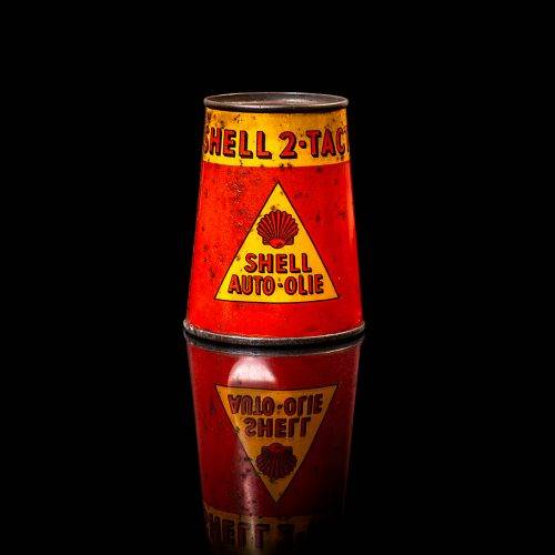Vintage Shell oil cans with red and yellow branding from the 1900-1920 old logo Vintage Shell oil cans from 1900-19255, featuring the old logo. The photo showcases an antique tin red with yellow accents, displaying the historic Shell emblem. Shot in a studio against a solid black background