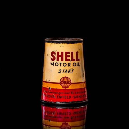 Rare and unique vintage conical shell oil can from 1900–1950 with a red base and yellow accents, featuring the classic shell logo. This antique, cone-shaped motor oil tin is showcased in a studio setting against a solid black background."