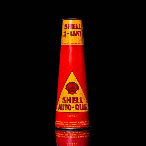 Rare and unique vintage conical shell oil can from 1900–1950 with a red base and yellow accents, featuring the classic shell logo. This antique, cone-shaped motor oil tin is showcased in a studio setting against a solid black background."